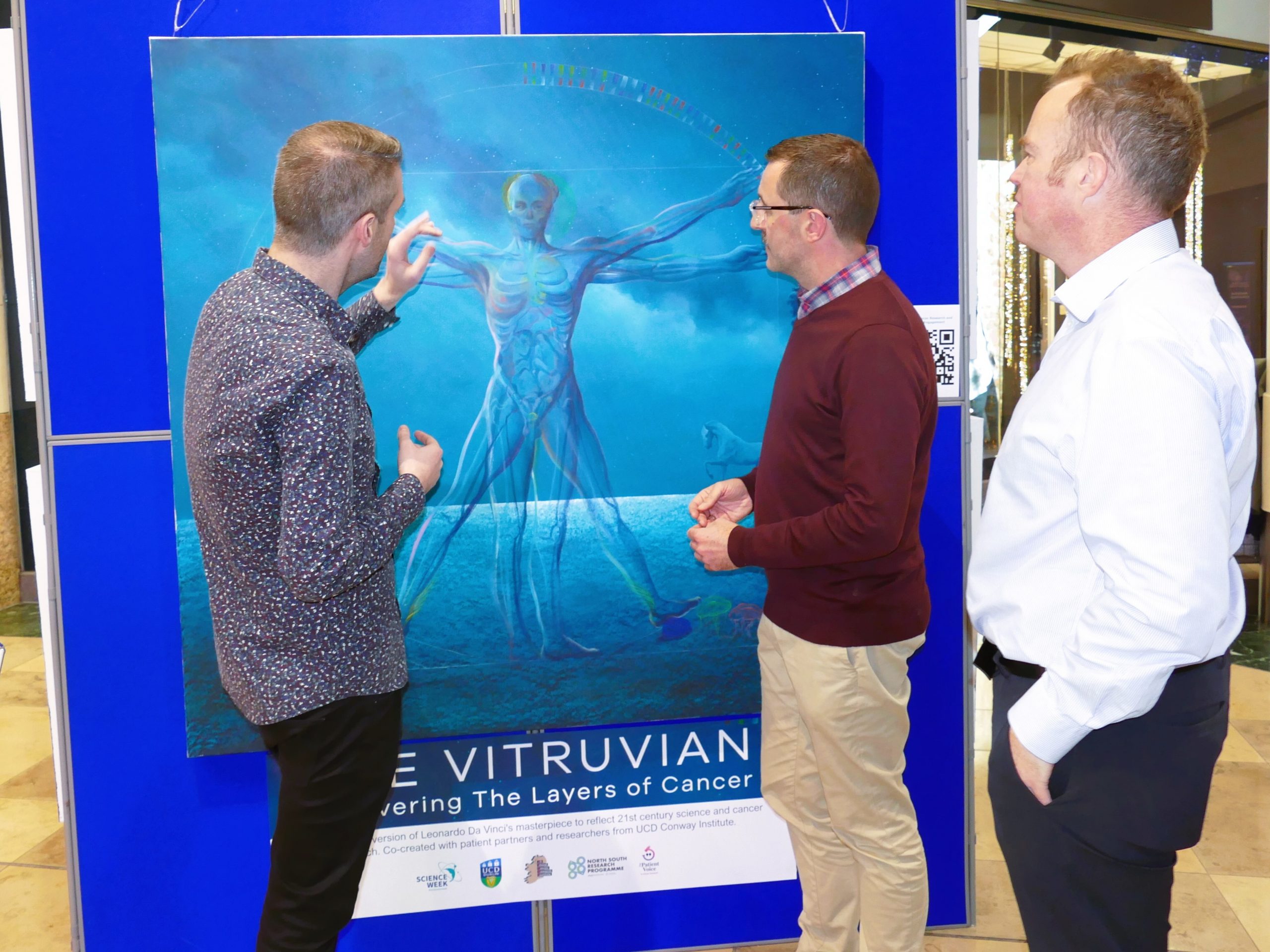 L-R: The artist Vincent Devine, who has reimagined Leonardo da Vinci’s ‘Vitruvian Man’ to celebrate the cancer research taking place at the All-Island Cancer Research Institute, with Cathal Nolan (HSF) and Professor William Gallagher (UCD, AICRI). 