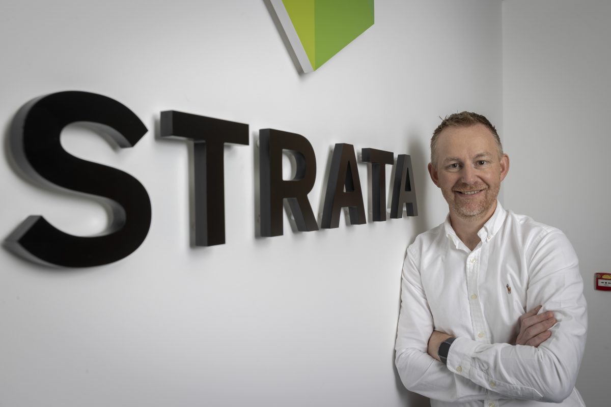 Enda Grimes with the Strata logo